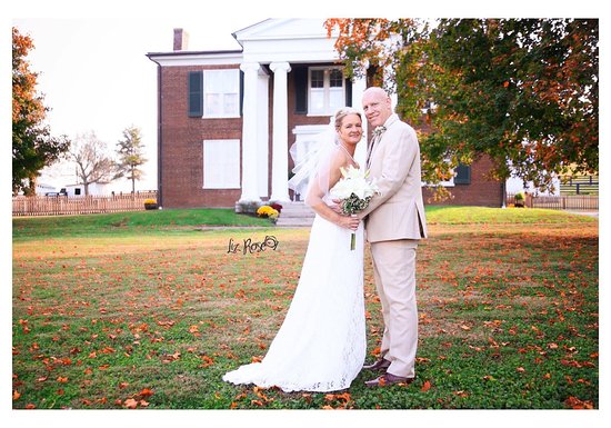 Bride and Groom in front of house